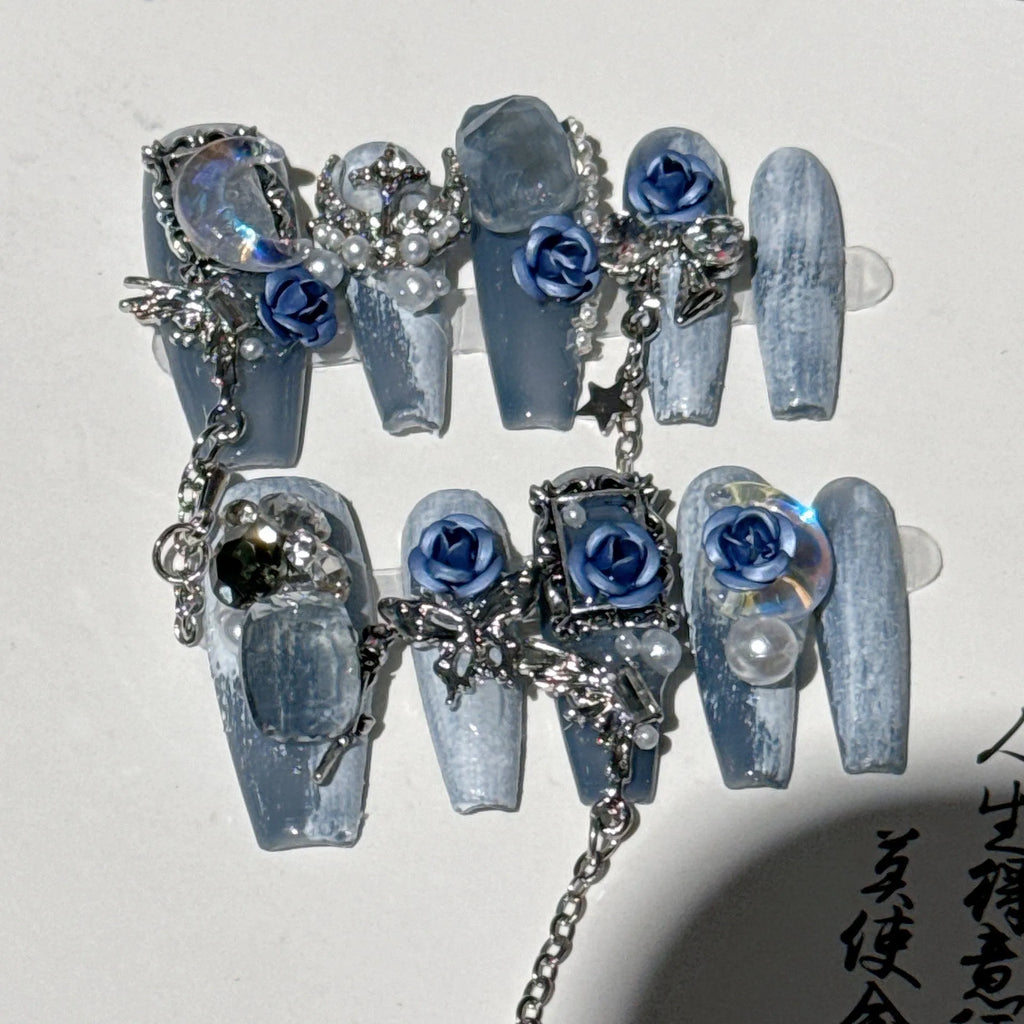 Heavy industry blue evening manicure nails with twinkling rose and flower patterns in four sizes