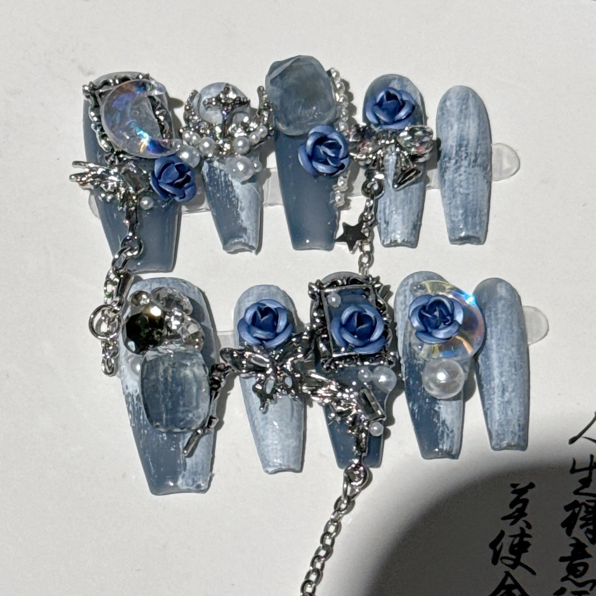 Heavy industry blue evening manicure nails with twinkling rose and flower patterns in four sizes