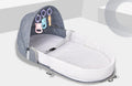 Portable foldable baby anti-mosquito isolation bed with grey cotton linen fabric, open on a grassy area