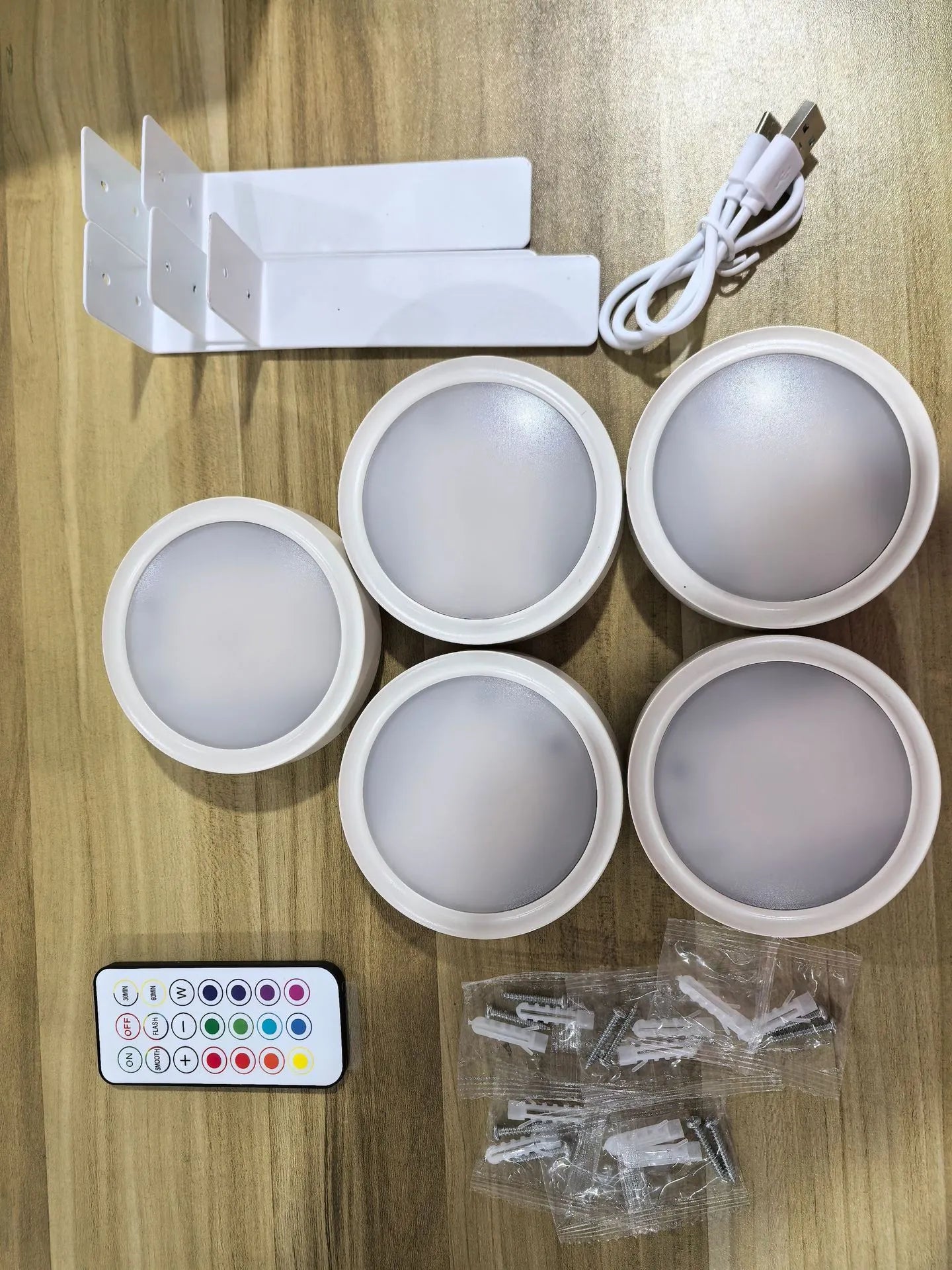 Wireless rechargeable LED painting lamp with magnetic belt attached to a metal frame, remote control nearby.