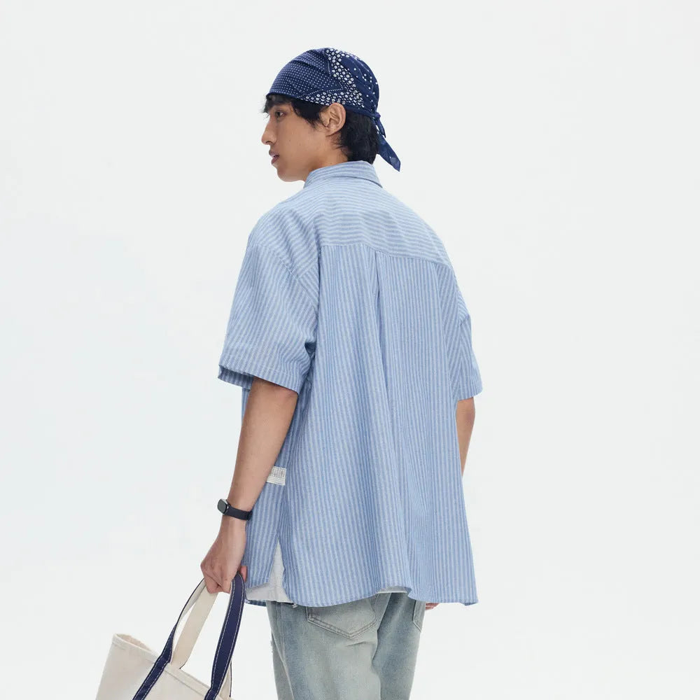 Blue striped short-sleeved shirt overalls with loose fit design on mannequin