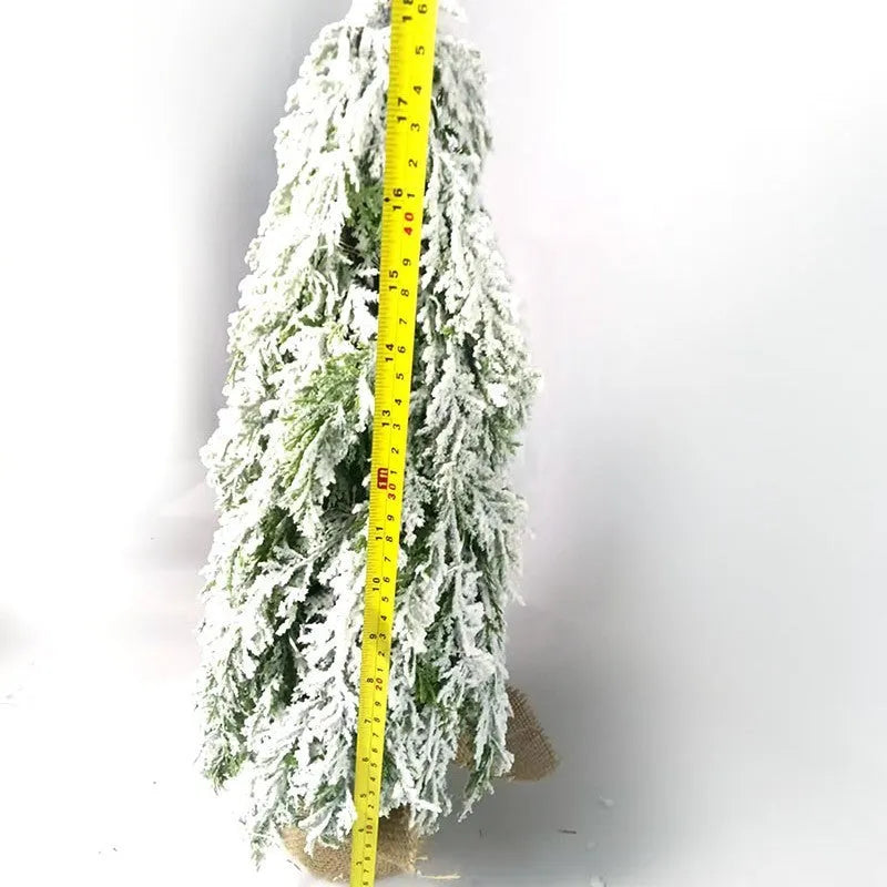 Small 24-inch artificial Christmas tree with battery-powered lights and PE simulated snow spray on branches