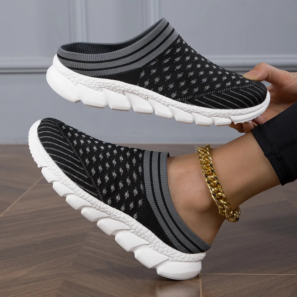 Women's black Flyknit casual shoes with striped pattern, hollowed-out design, and sewing lines on a lightweight sole.