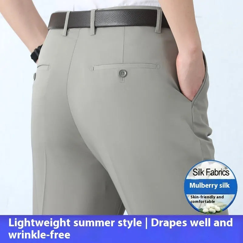 Man wearing dark blue straight-leg suit pants with a high waist, made from a non-ironing mulberry silk blend fabric.
