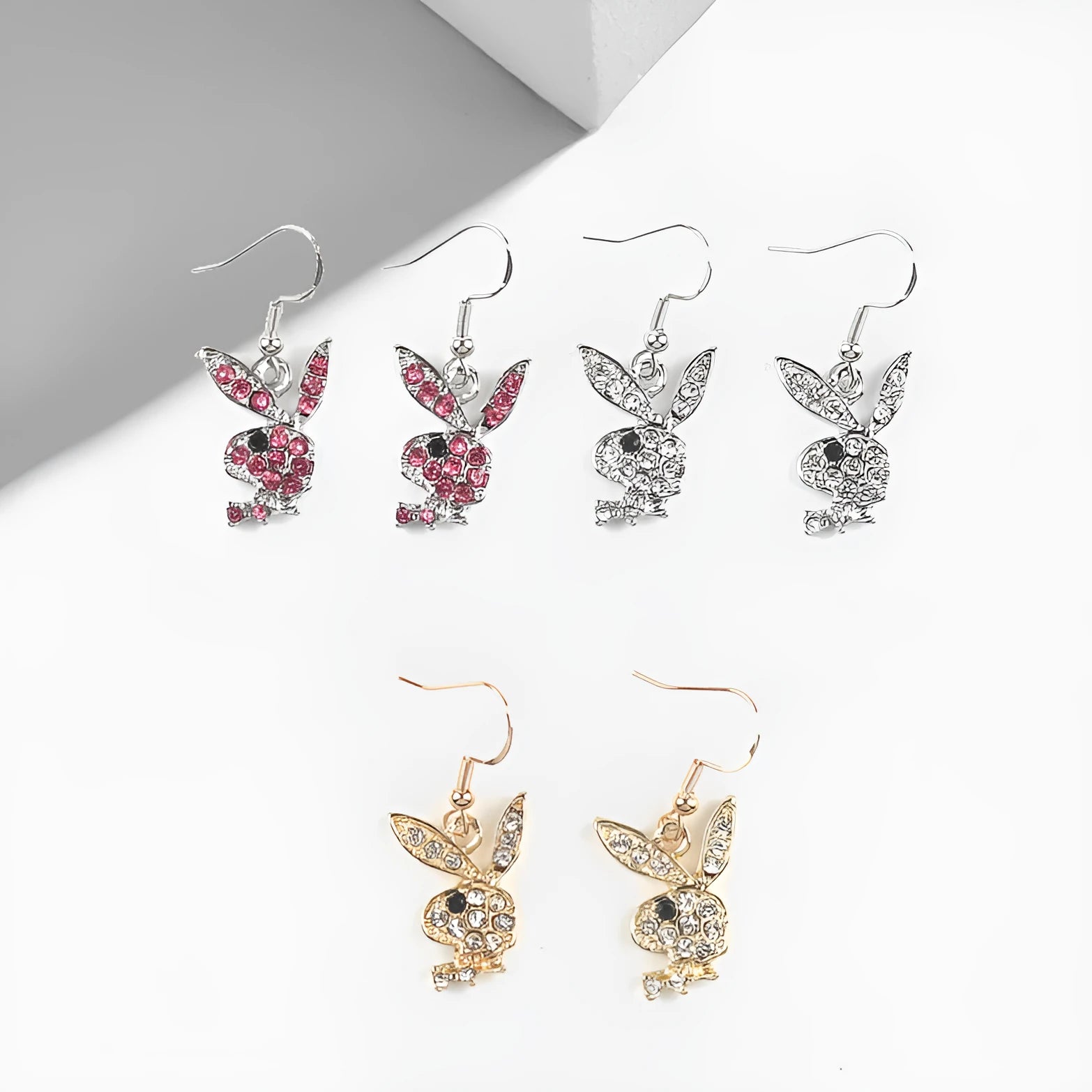Cute rabbit-shaped stud earrings in silver, pink, or gold colour on a white background.