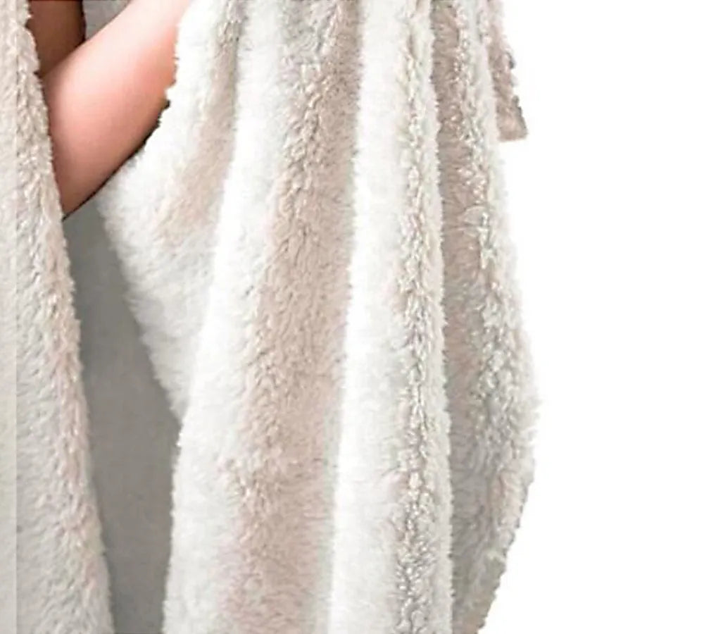 Round coral fleece flannel blanket rolled in a burrito style, showing soft texture and printed design.