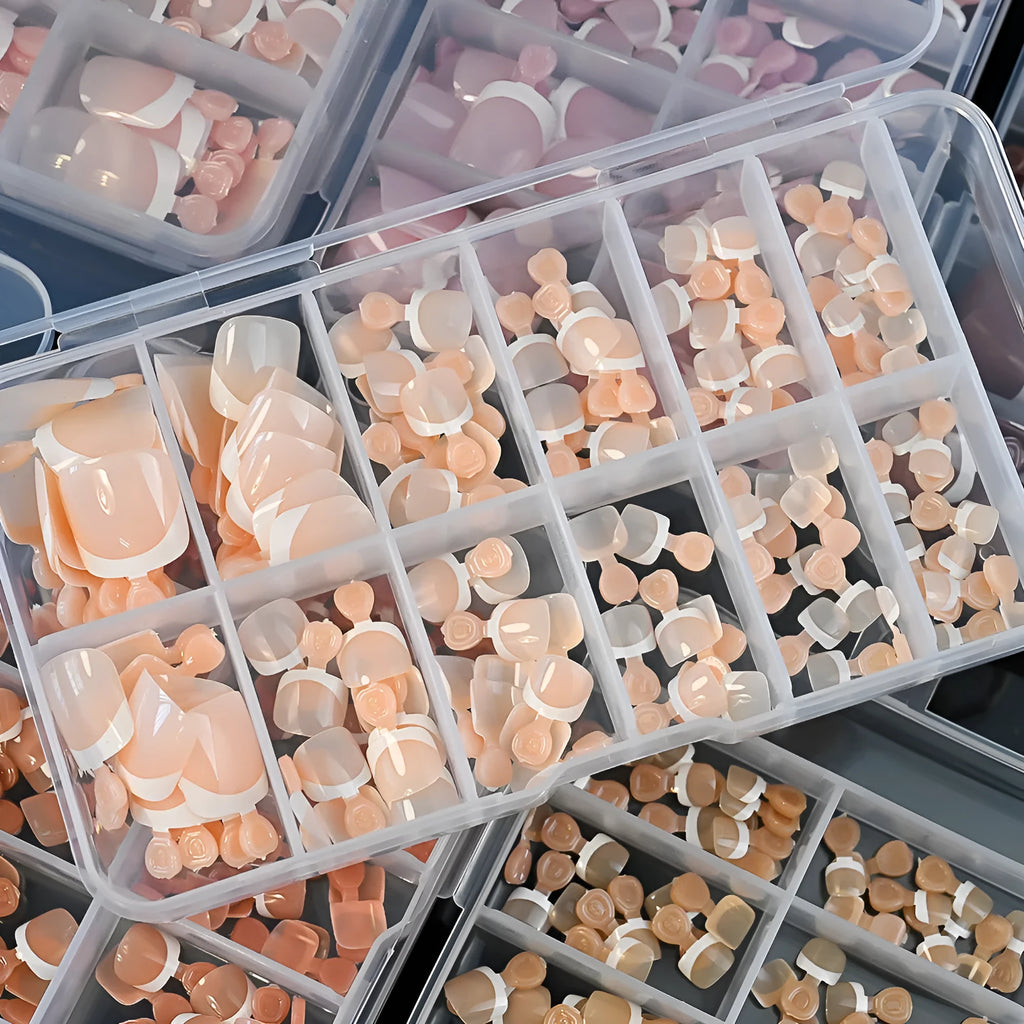 Open box showing 120 French white tip nude square false toe nails in assorted shades.