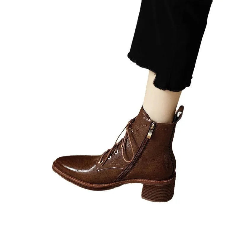 Women's black pointed toe short tube ankle boots with 5.5cm heel on wooden floor