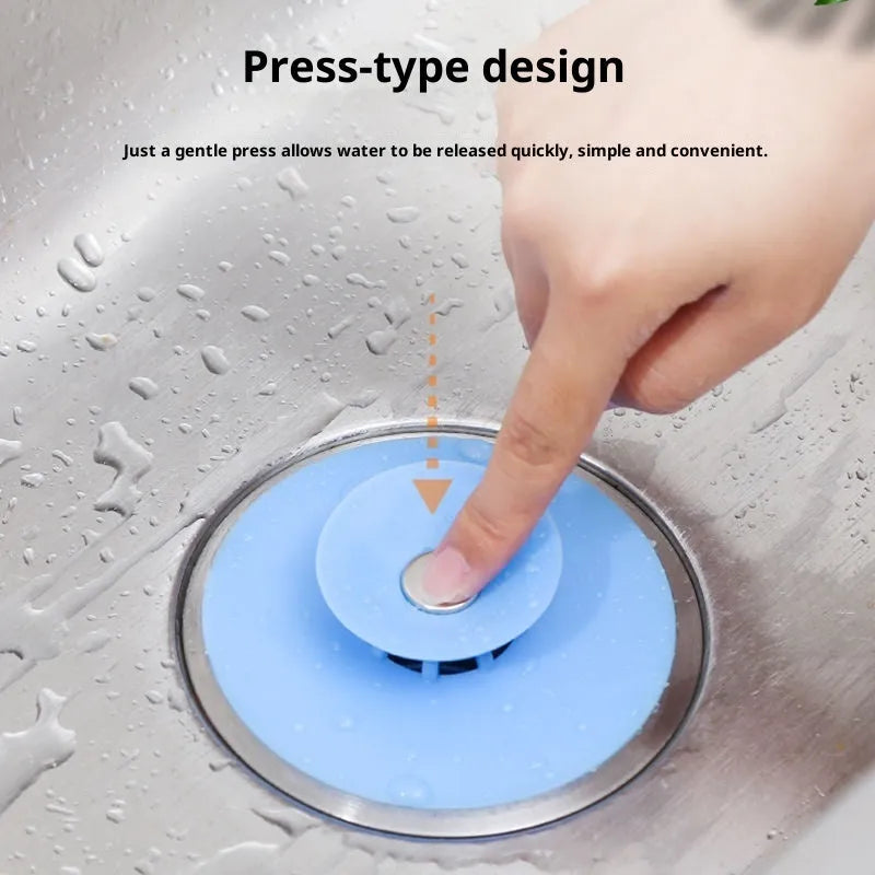 UFO-style silicone press sink drain cover in white on a modern kitchen sink