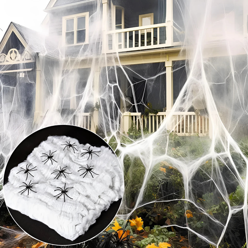 White cotton Halloween spider web decoration draped with plastic spider props.