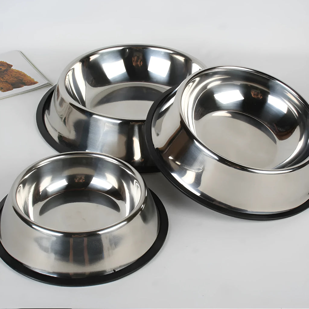 Classic stainless steel pet bowl with non-slip rubber base on a tiled floor