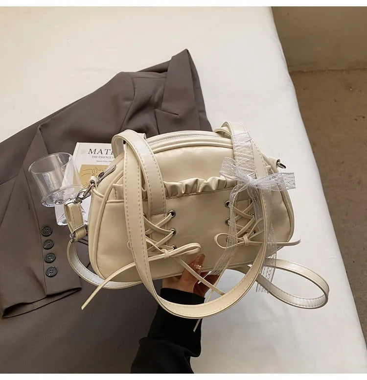 Women's casual bandage bow handbag in PU with shoulder strap and sewing thread detailing.
