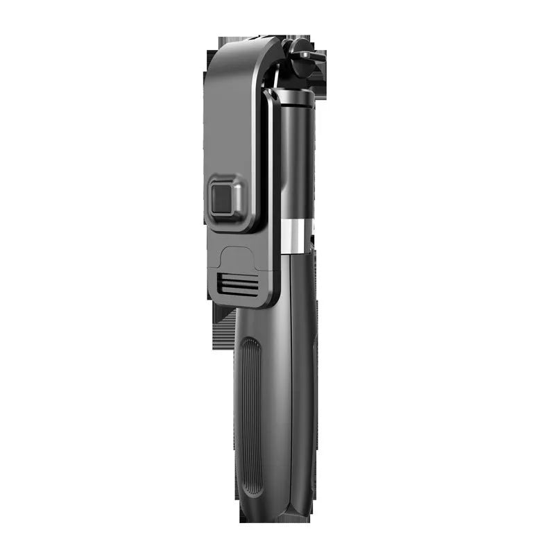 Black and white adjustable Bluetooth selfie stick tripod with wireless remote control extended next to smartphone.
