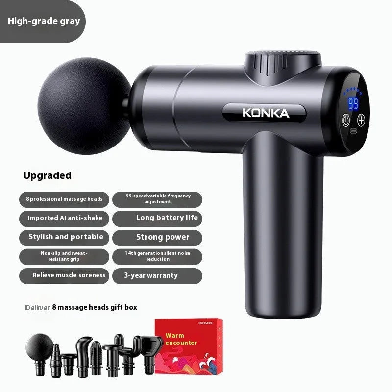 Konka professional electric mini massage gun in grey colour with multiple massage head attachments on a table.