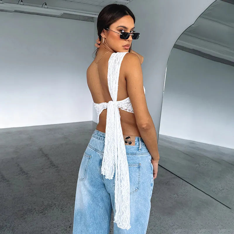 Women's sleeveless lace backless top with asymmetrical neckline in a solid colour.