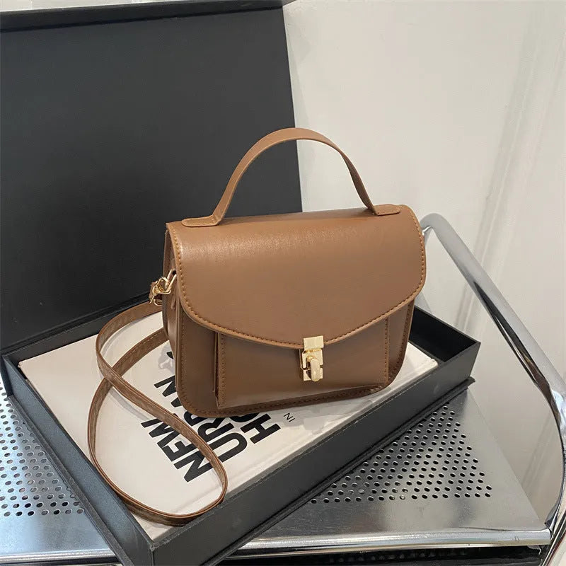 Retro style PU messenger bag in horizontal square format with sandwich pocket and crossbody strap