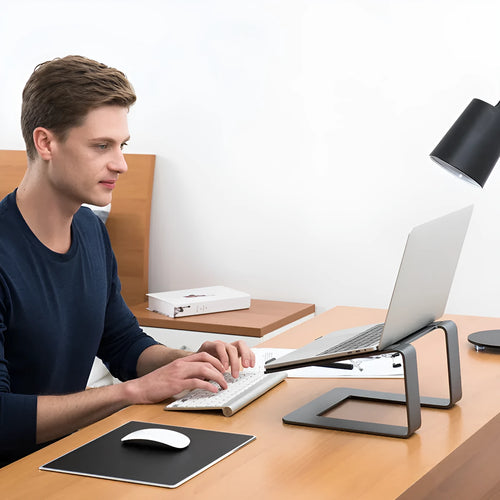 Aluminium alloy laptop stand in black or silver measuring 29.9 x 25.8 x 18.5 cm on a desk