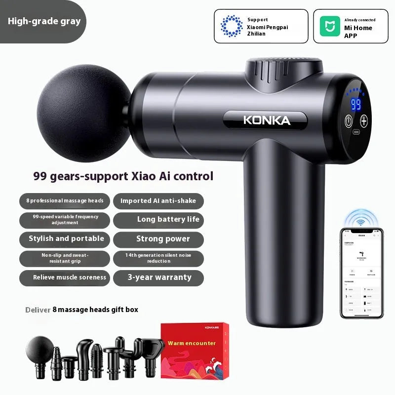 Konka professional electric mini massage gun in grey colour with multiple massage head attachments on a table.