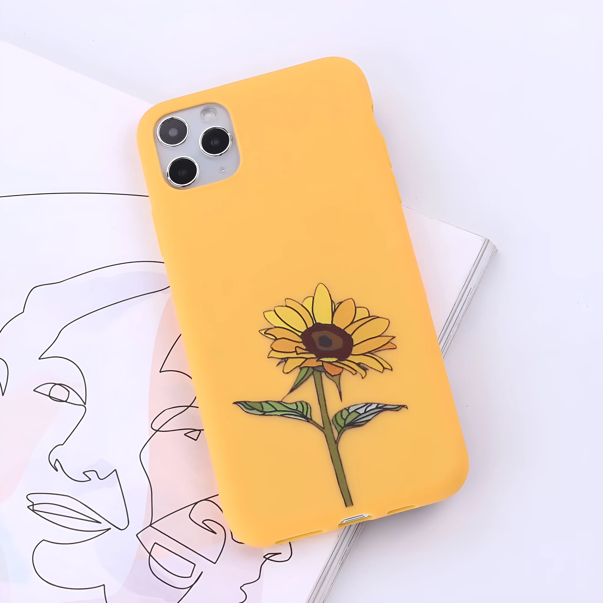 Slim TPU mobile phone case for iPhone on a table, showing one of 14 available colour options.