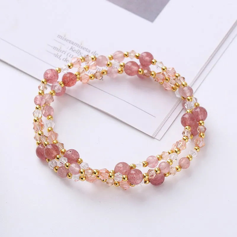 Colourful three-ring crystal bracelet with tourmaline, strawberry quartz, and amethyst beads on an adjustable cord.