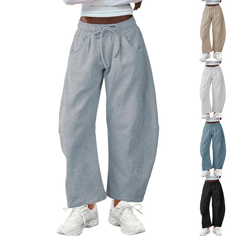 Loose grey cropped sweatpants with elastic drawstring waist and pockets on a mannequin