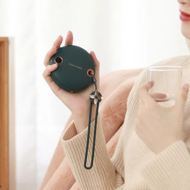Green hand warmer power bank with digital display showing battery percentage and temperature setting