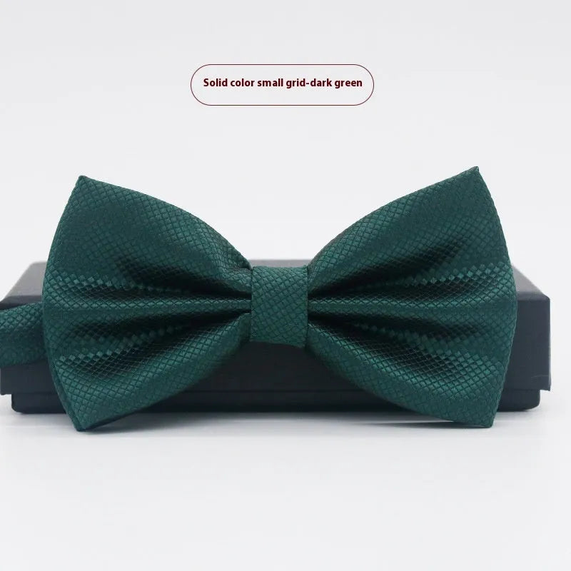 Men's flat head style polyester bow tie in a solid colour, shown with adjustable neck strap.