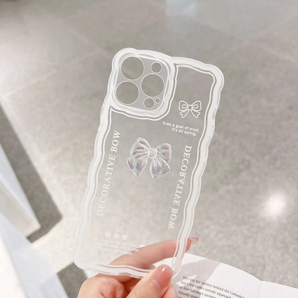 Clear transparent iPhone case with a raised 3D ice-effect bow design on the back.