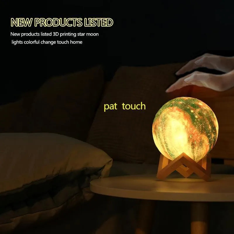 3D printed white lunar lamp sphere glowing on a surface, showing crater texture with a remote control nearby.