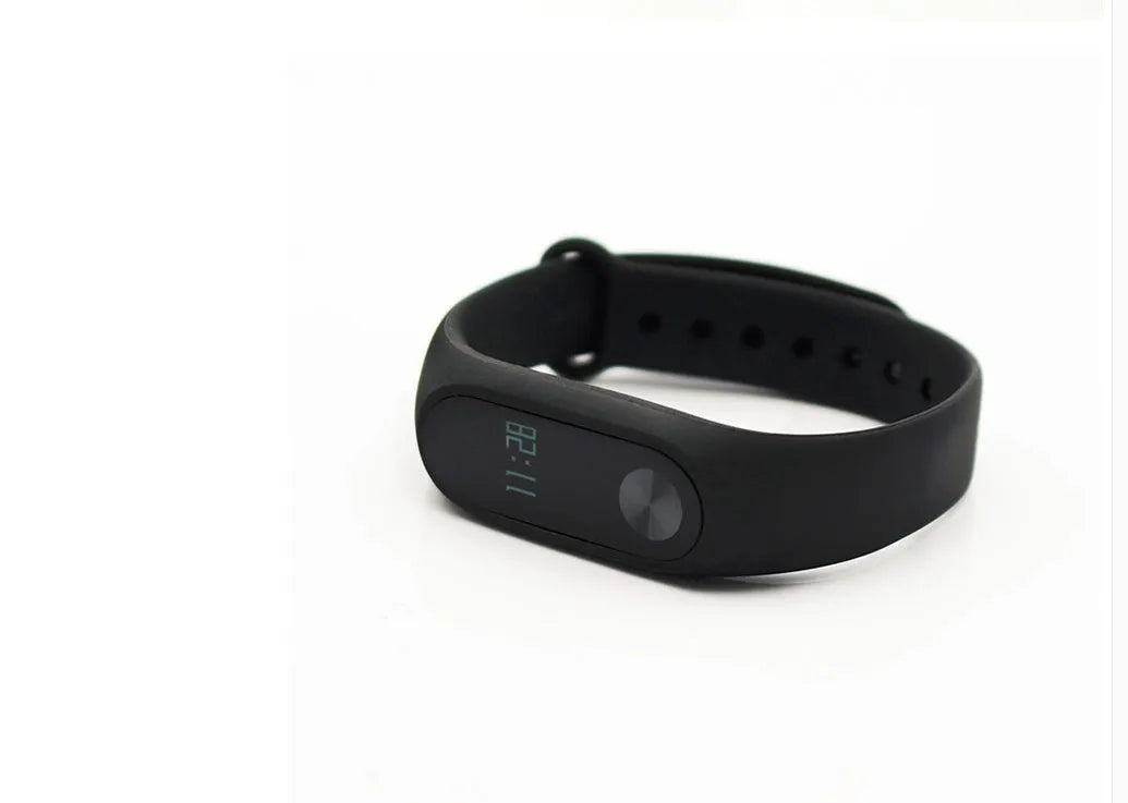 Xiaomi Mi Band 2 black fitness tracker on wrist showing OLED display
