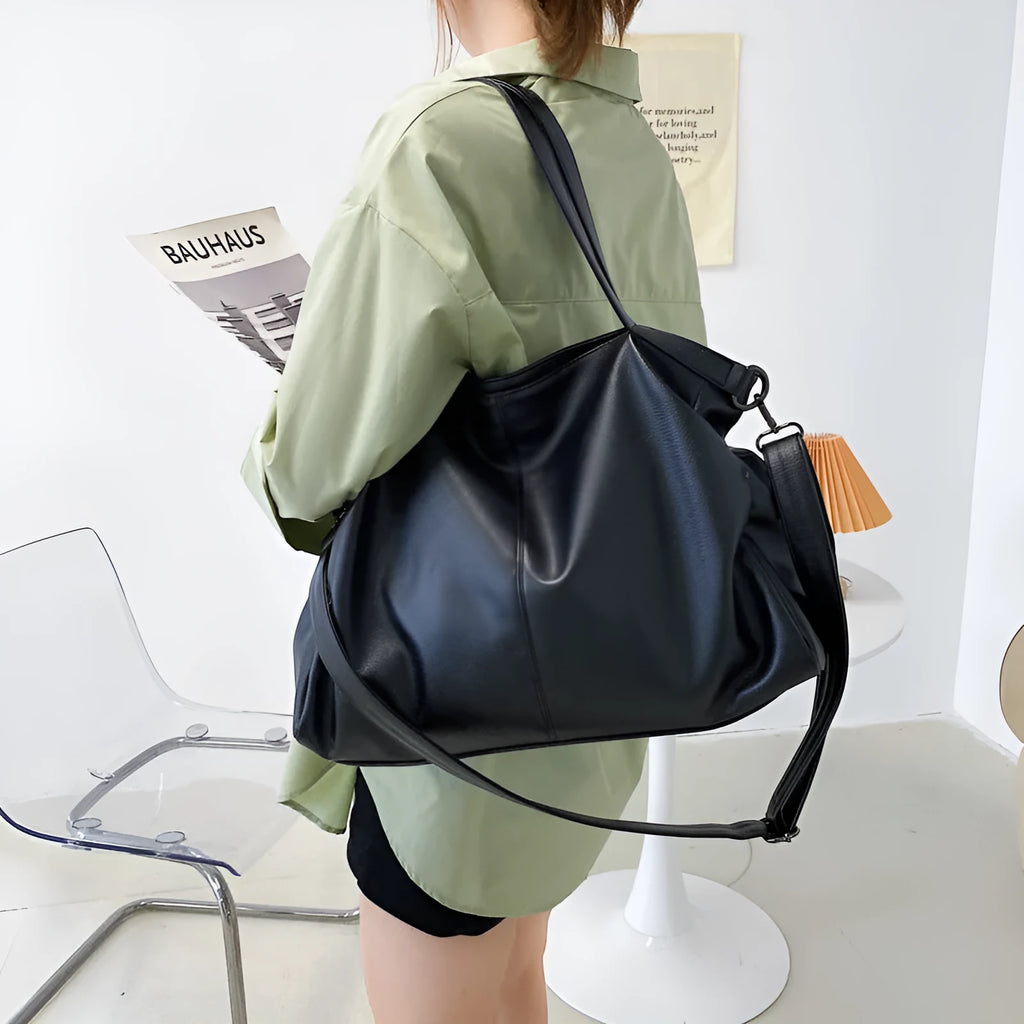 Large soft black PU messenger tote bag with car suture detailing and a long shoulder strap