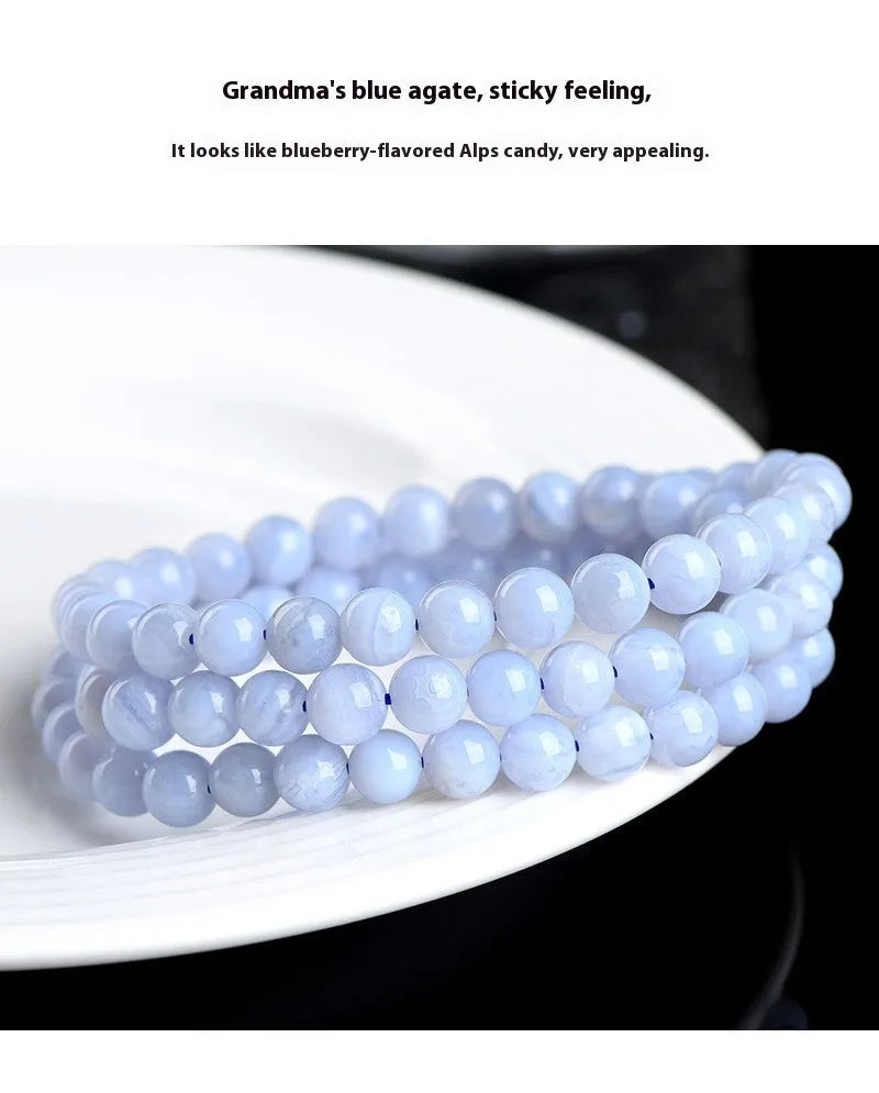 Blue agate bracelet with natural striped patterns, Ruyi design elements, and scattered bead arrangement