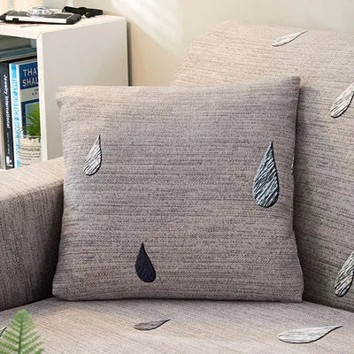 Geometric patterned stretch sofa slipcover fitted on a modern two-seater sofa.