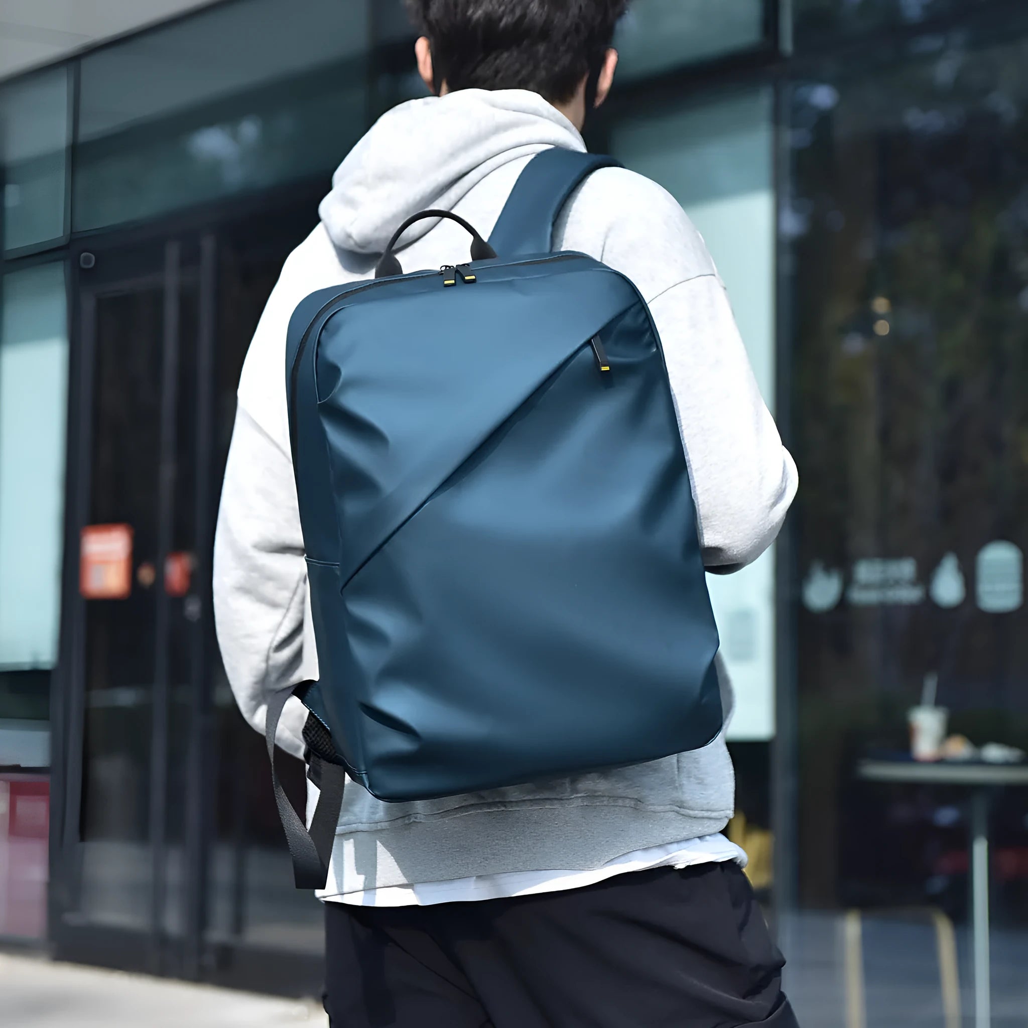 Large capacity waterproof backpack in black blue or grey colours made from PU leather with simple design