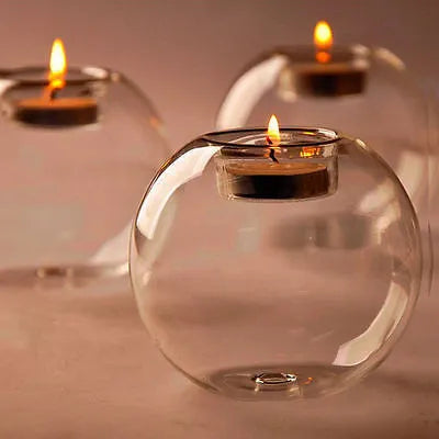 Clear round hollow glass candle holder for a tea light on a table