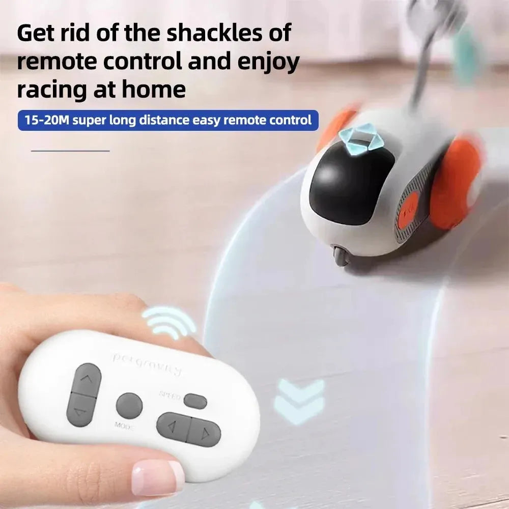 Blue or orange smart electronic cat toy car with feather teaser and remote control on floor.