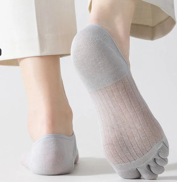 Modal five-finger boat socks in black, shown on a foot with invisible no-show style.