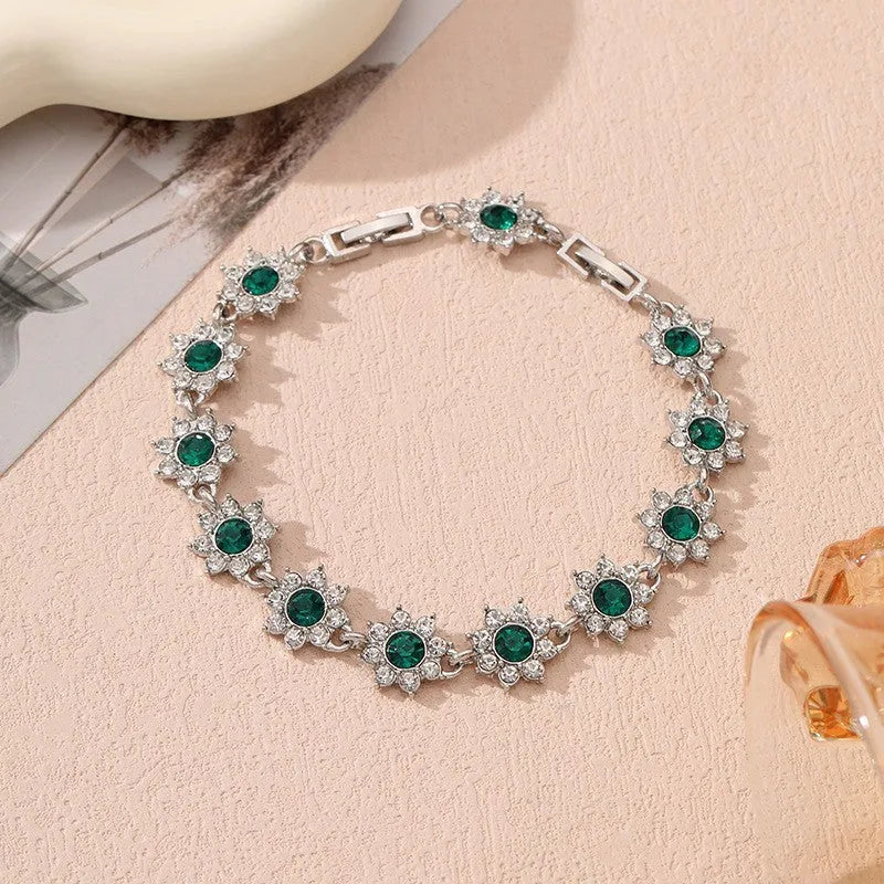 Floral zinc alloy bracelet with electroplated gold or silver finish and gemstone colour variants