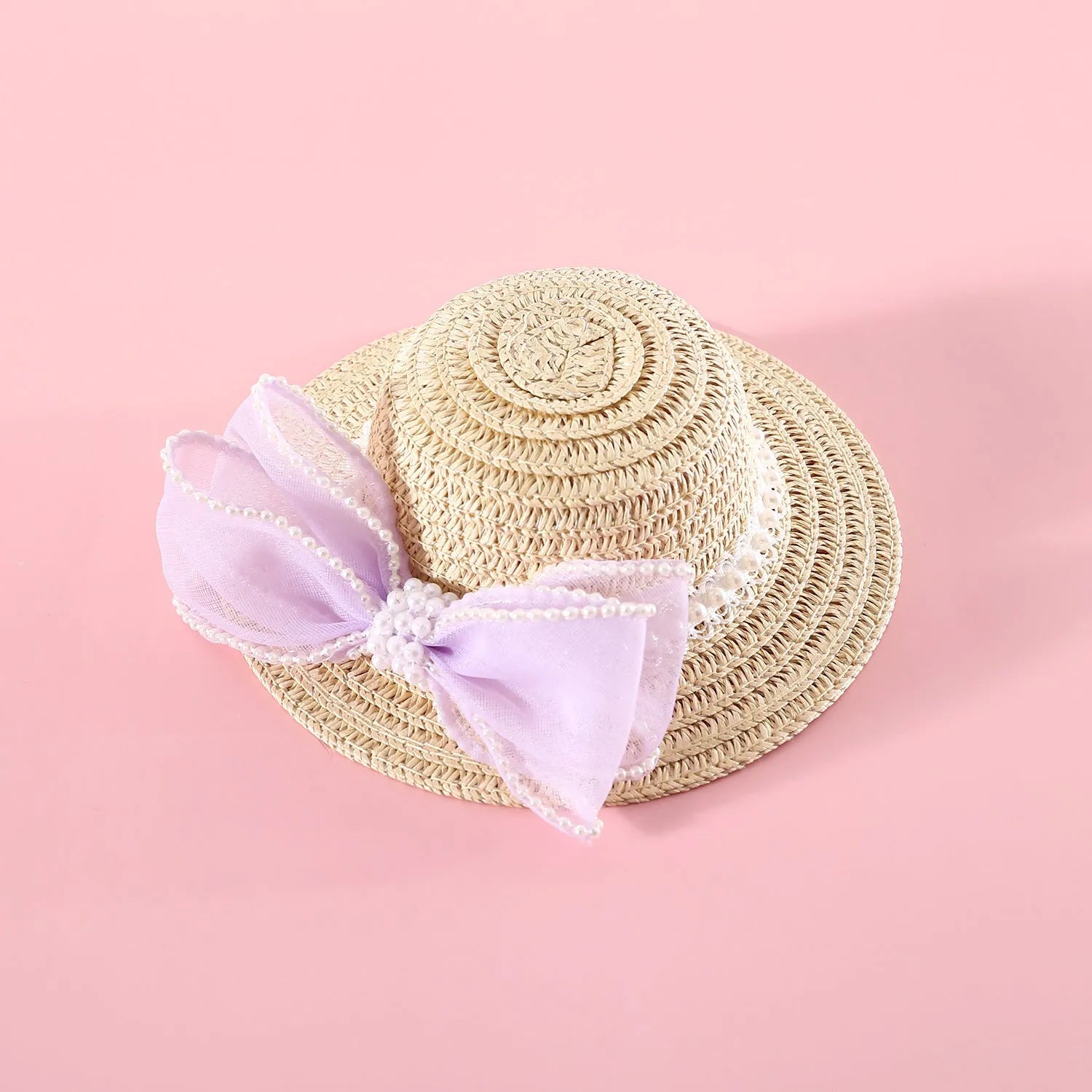 Pet cat wearing princess-style straw hat with woven pearl bow decoration in lafite leaves material