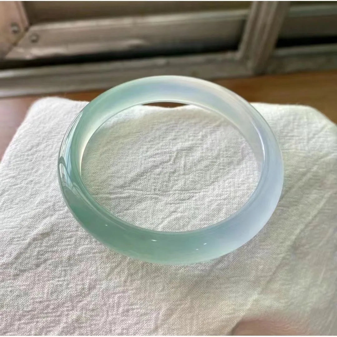 Natural agate wide tyre bracelet showing colour variations including pink, white, blue and green options
