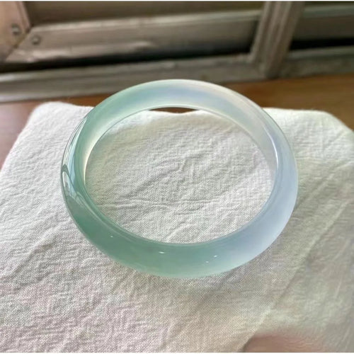 Natural agate wide tyre bracelet showing colour variations including pink, white, blue and green options