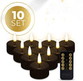 Set of four black plastic LED tealight candles showing warm white flame effect