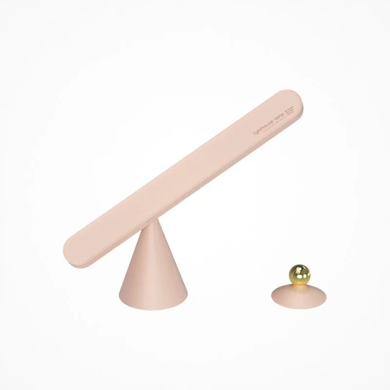 White geometric table lamp with touch switch and USB cable on a wooden desk.