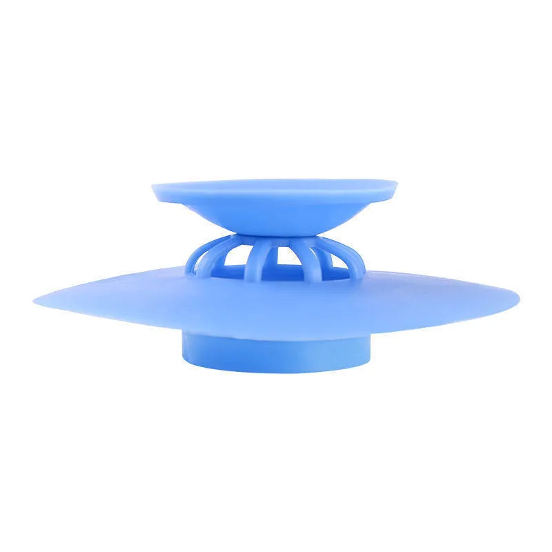 UFO-style silicone press sink drain cover in white on a modern kitchen sink