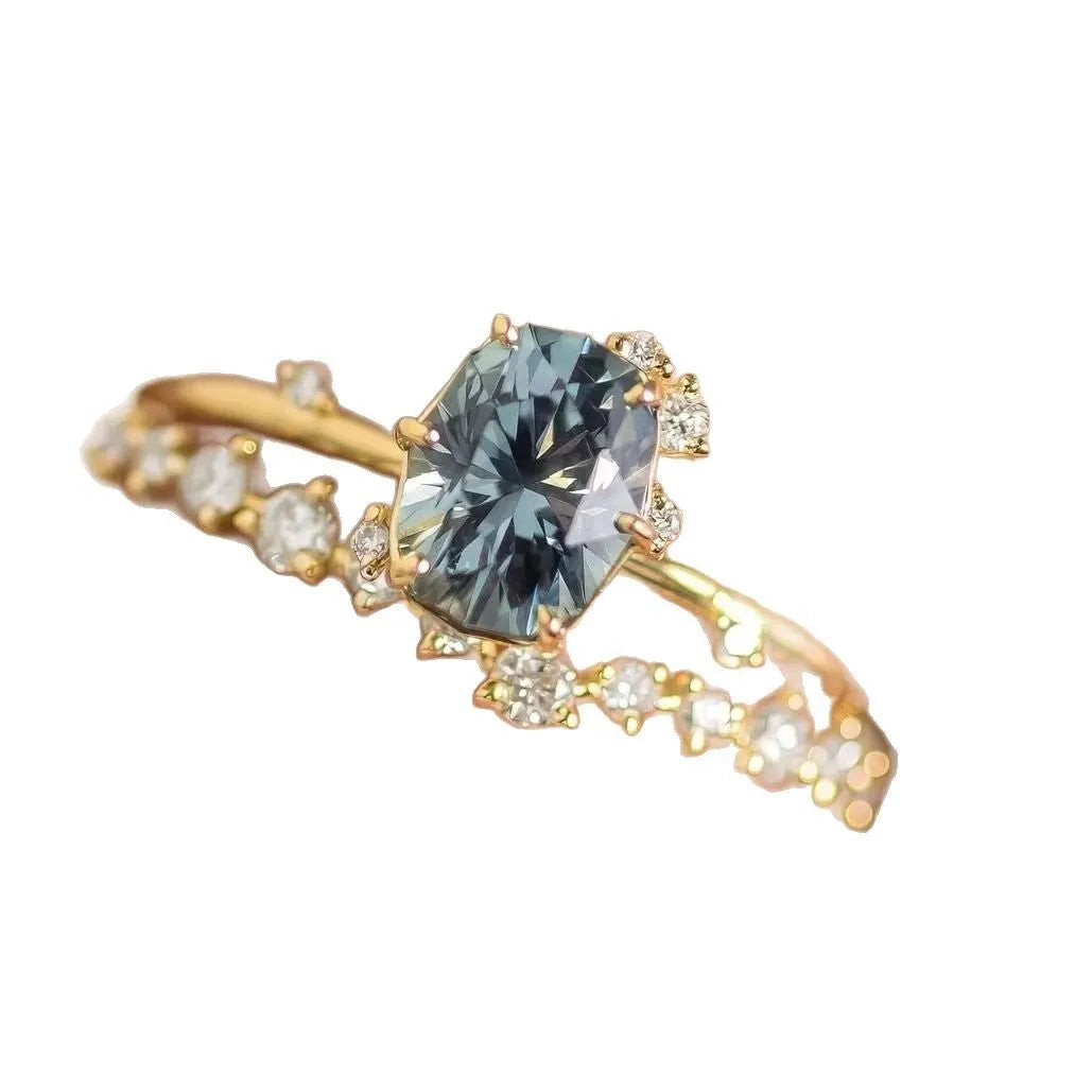 Gold plated floral women's ring with green zircon stone inlay on model finger