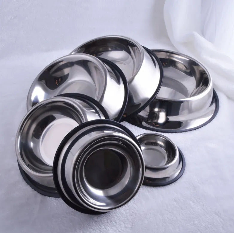 Classic stainless steel pet bowl with non-slip rubber base on a tiled floor