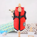 Waterproof dog coat with integrated harness in red, shown on a dog