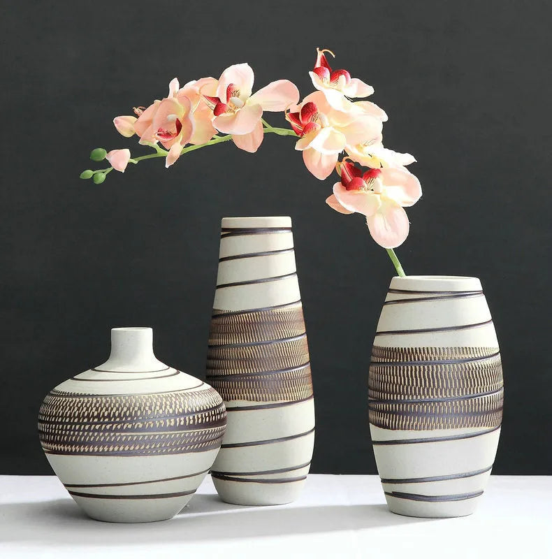 Three-piece ceramic vase set in low, medium, and tall sizes with vintage finish on a tabletop