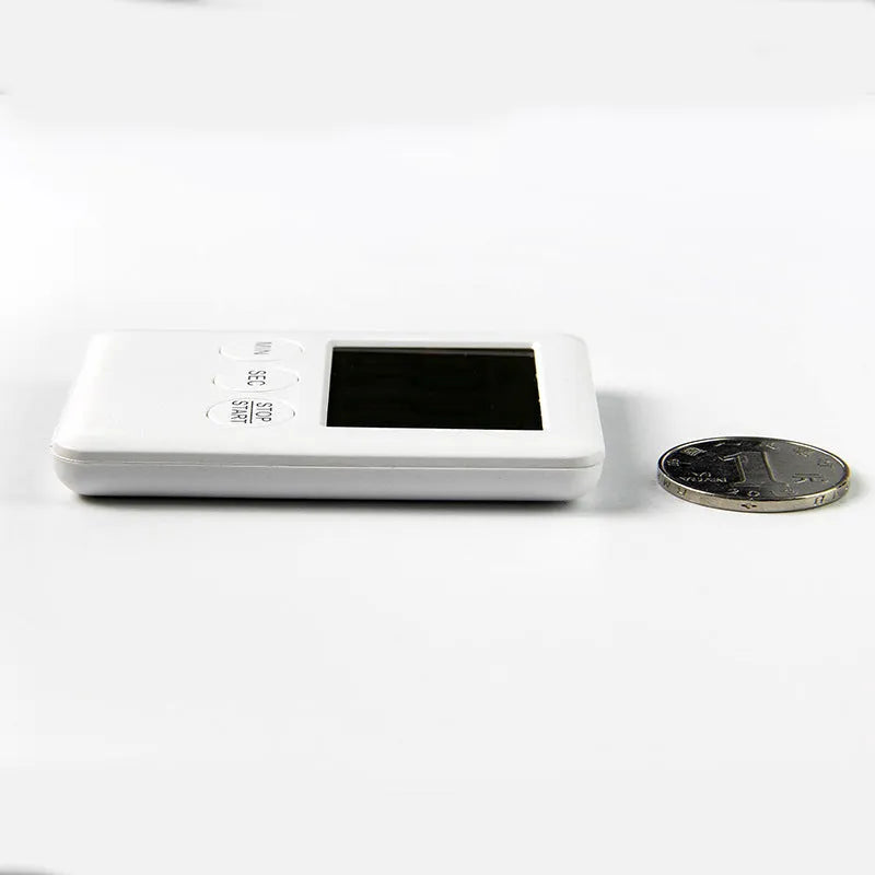 Black and white digital kitchen timer with magnetic back showing count up, countdown and alarm functions.