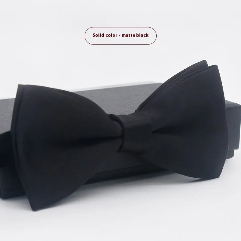 Men's flat head style polyester bow tie in a solid colour, shown with adjustable neck strap.